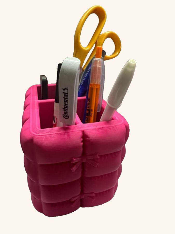 Custom 3D printed desk organiser in pink holding pens and scissors